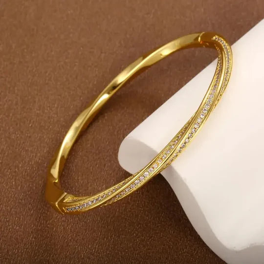 Elegant crystal bracelet with two rows of gold detailing.